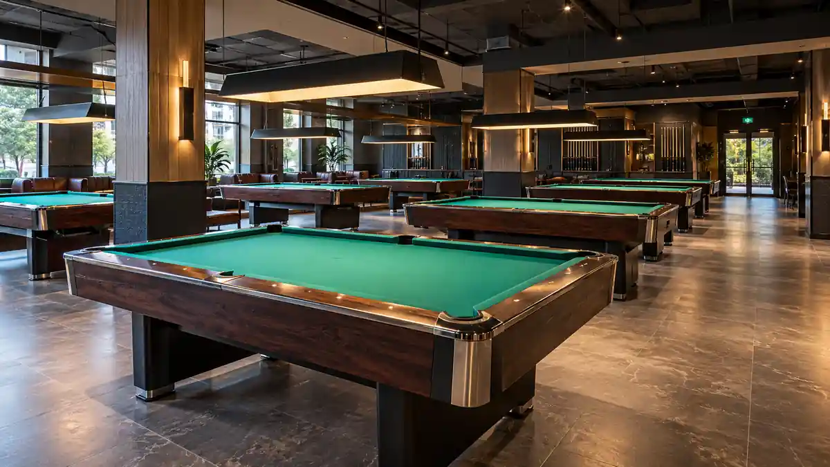 Empty commercial billiard club showing pool table spacing and access routes